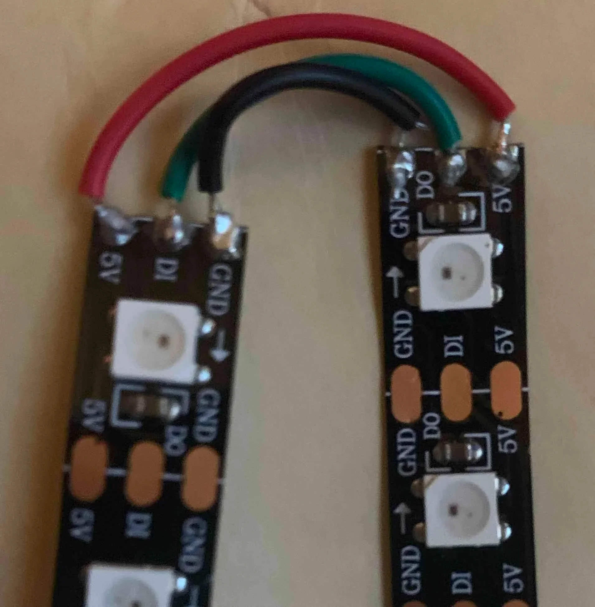 Strip 1-2 (every strip that does not need power injection) match 5V Data and GND to next strip following directions of arrows.
